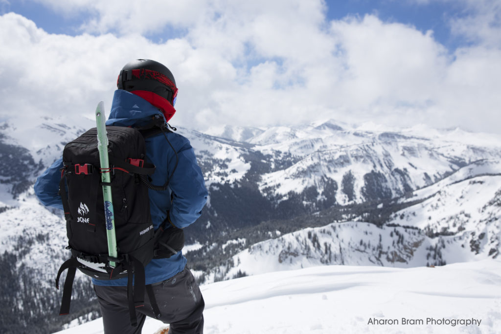 Skier with backpack and ice axe